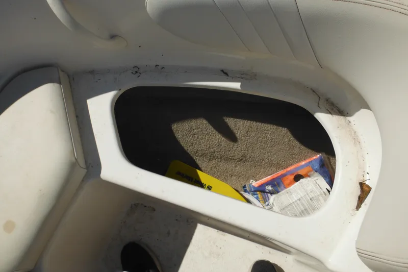 Slide: The Image of Storage compartment in 2003 Chaparral 180 SS boat with items inside. - 18