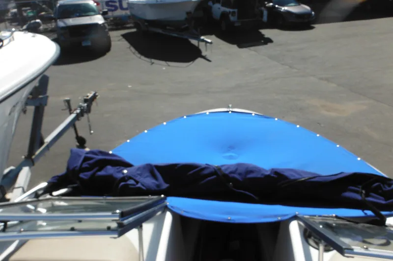 Slide: The Image of 2003 Chaparral 180 SS boat with blue cover, parked on a trailer. - 21