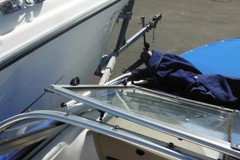 Slide: The Image of 2003 Chaparral 180 SS boat on trailer with blue cover and windshield. - 23