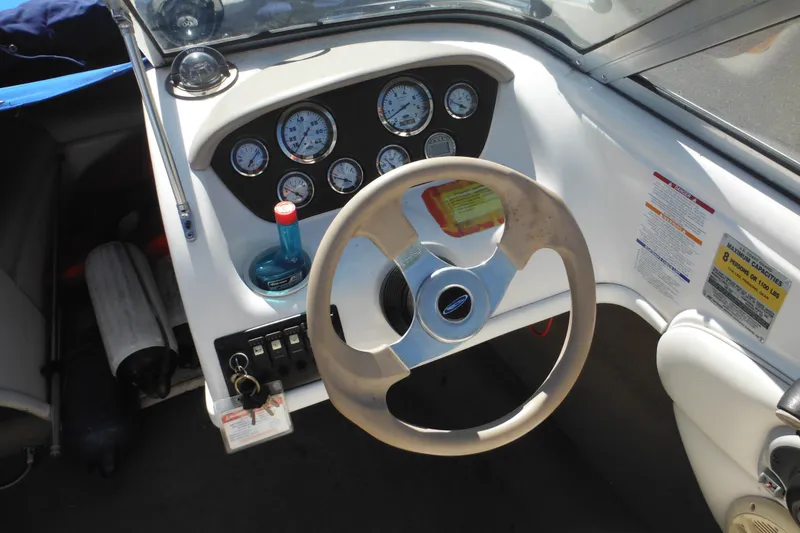 Slide: The Image of 2003 Chaparral 180 SS boat dashboard with steering wheel and instrument gauges. - 24