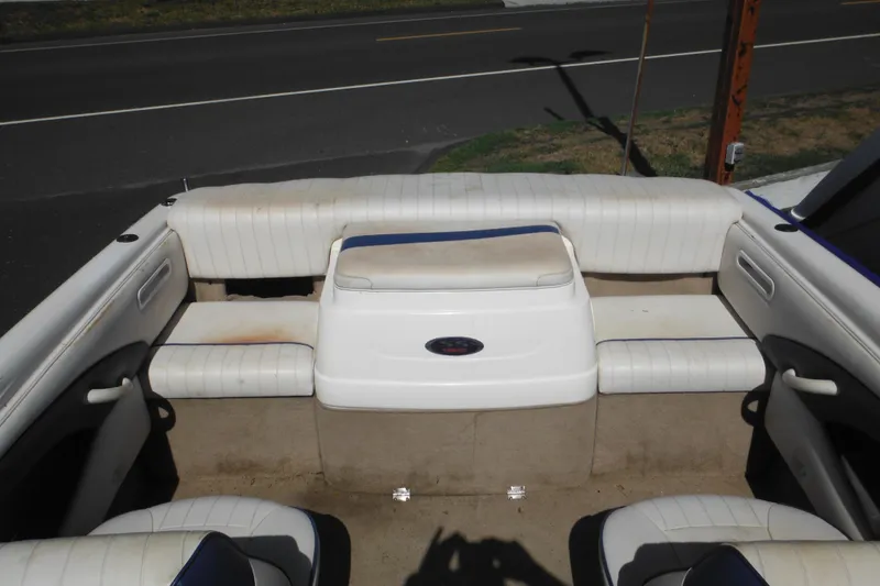 Slide: The Image of 2003 Chaparral 180 SS boat interior with white seating and carpeted floor. - 28