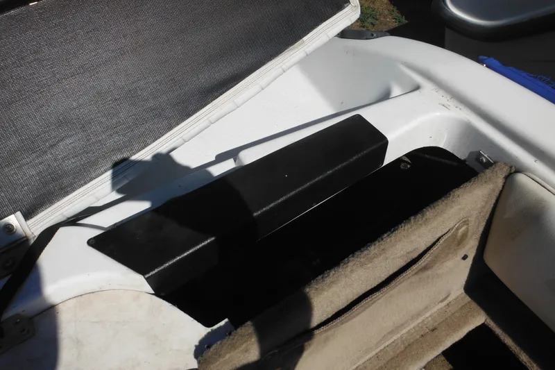 Slide: The Image of 2003 Chaparral 180 SS boat interior storage compartment with open lid. - 33
