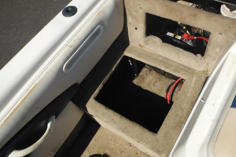 Slide: The Image of 2003 Chaparral 180 SS boat interior showing battery compartment and wiring. - 34
