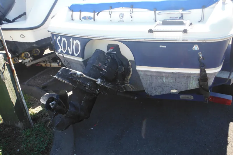 Slide: The Image of 2003 Chaparral 180 SS boat with visible outboard motor and trailer. - 8