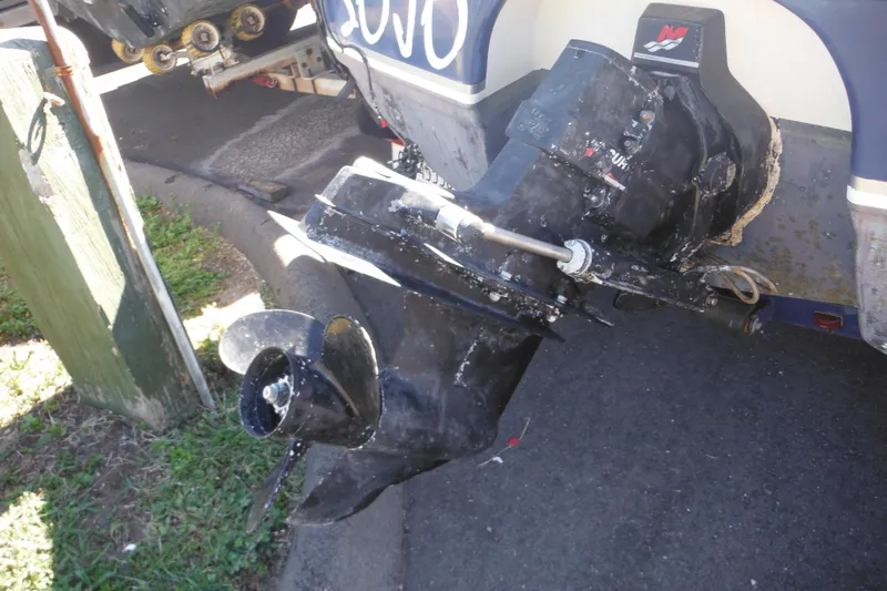 Slide: The Image of 2003 Chaparral 180 SS boat outboard motor with visible wear and propeller. - 9