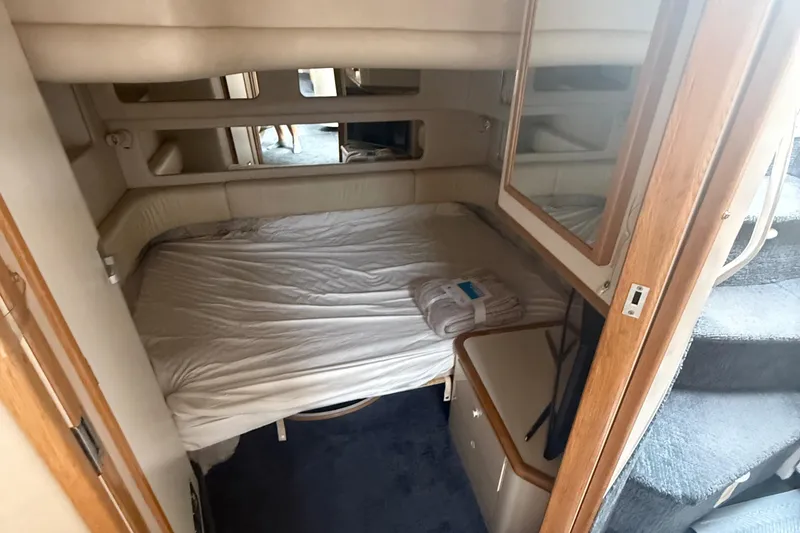 Slide: The Image of Interior cabin of 1996 Sea Ray 450 Sundancer with bed and mirror. - 10