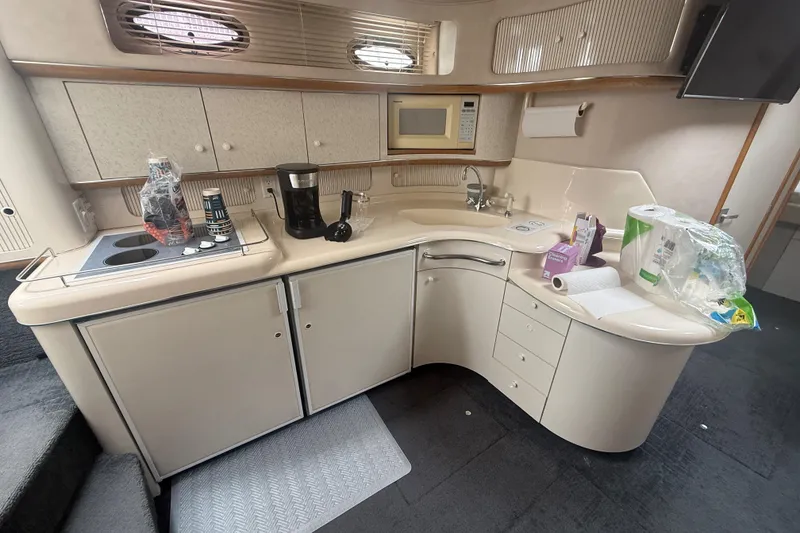 Slide: The Image of 1996 Sea Ray 450 Sundancer yacht kitchen with sink, microwave, and coffee maker. - 11