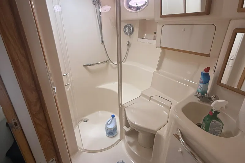 Slide: The Image of Bathroom interior of a 1996 Sea Ray 450 Sundancer yacht, featuring shower and sink. - 14