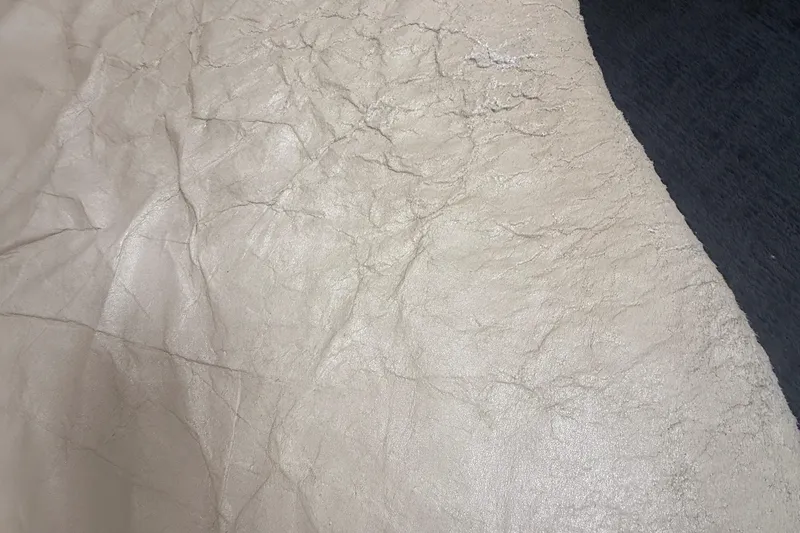 Slide: The Image of Close-up of textured beige leather, possibly from a 1996 Sea Ray 450 Sundancer. - 15