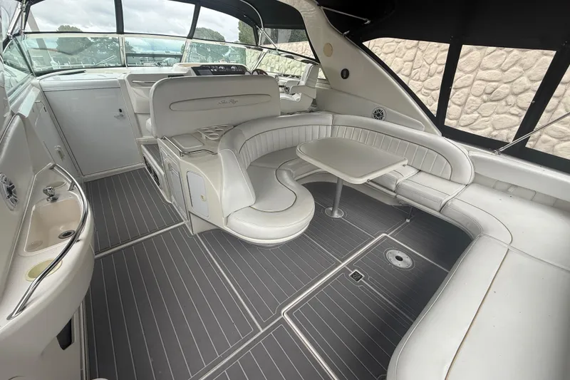 Slide: The Image of Interior of 1996 Sea Ray 450 Sundancer yacht with white seating and table. - 3