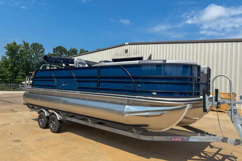 Slide: The Image of 2025 Trifecta 24 UL CS pontoon boat on trailer, parked outdoors. - 3