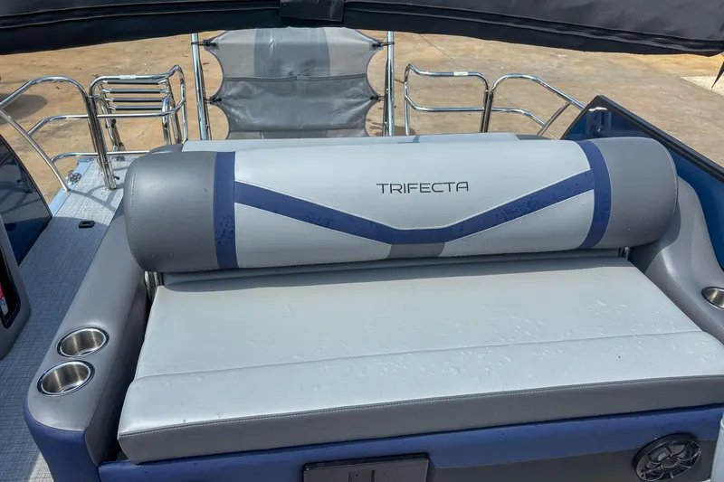 Slide: The Image of 2025 Trifecta 24 UL CS boat interior with cushioned seating and cup holders. - 5
