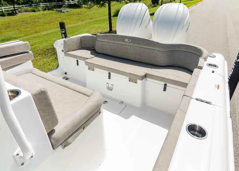 Slide: The Image of 2025 Sea Hunt Ultra 305 SE boat interior with cushioned seating and dual engines. - 9
