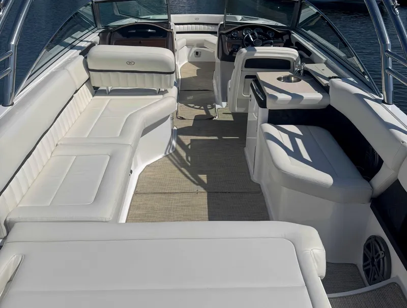 Slide: The Image of Luxurious interior of a 2016 Cobalt A28 boat with white seating and modern dashboard. - 10