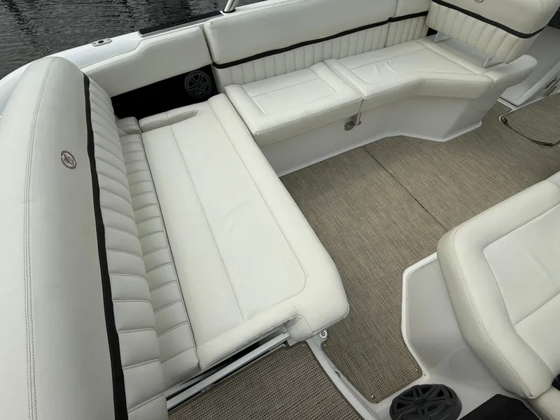 Slide: The Image of 2016 Cobalt A28 boat interior with white leather seating and beige carpet flooring. - 13