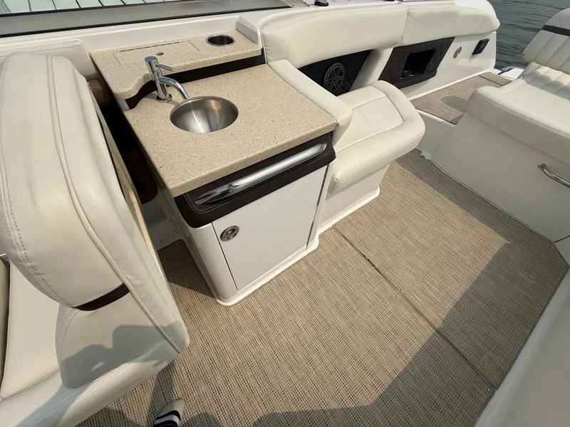 Slide: The Image of Luxury interior of 2016 Cobalt A28 boat with sink and seating area. - 16
