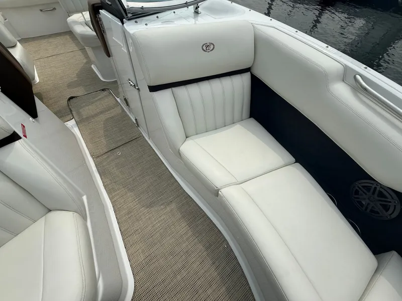 Slide: The Image of Interior of a 2016 Cobalt A28 boat with white leather seating and beige carpet. - 26