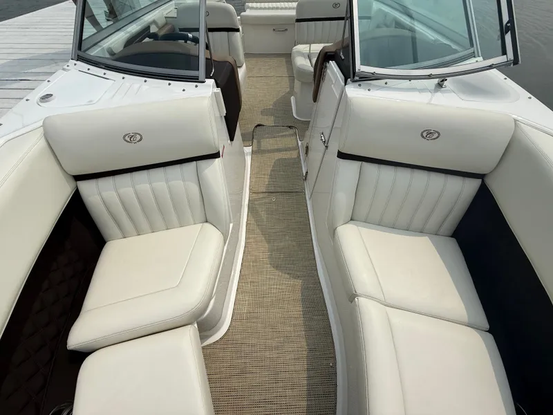 Slide: The Image of 2016 Cobalt A28 boat interior with white leather seating and open cockpit design. - 27