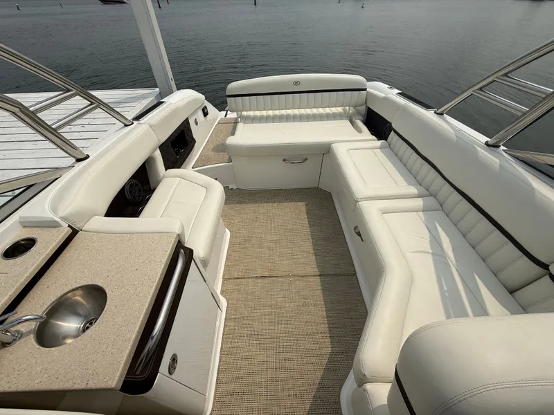 Slide: The Image of Luxurious interior of a 2016 Cobalt A28 boat with white seating and a small sink. - 29