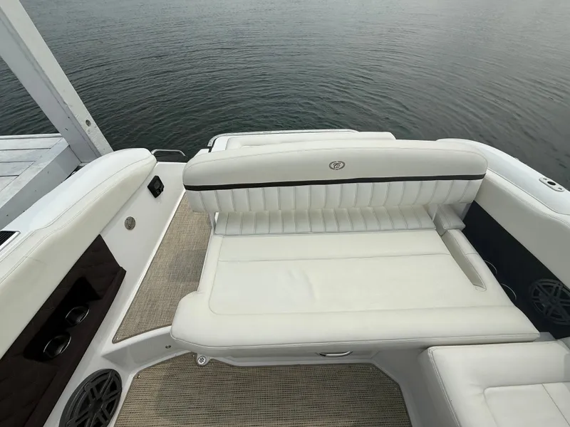 Slide: The Image of 2016 Cobalt A28 boat interior with white leather seating and cup holders. - 30