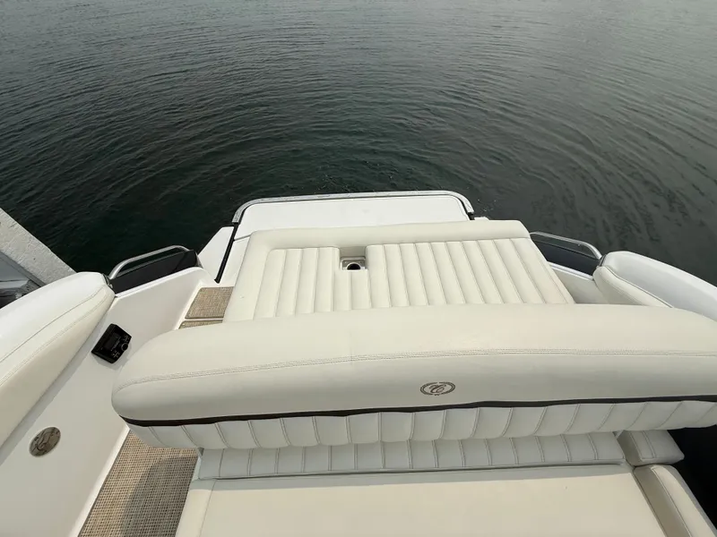 Slide: The Image of 2016 Cobalt A28 boat with white leather seating, overlooking calm water. - 31