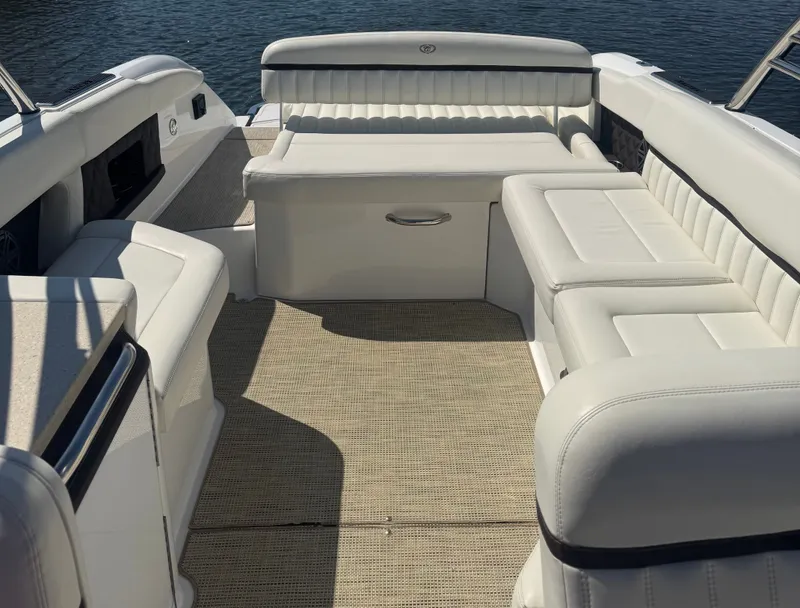 Slide: The Image of 2016 Cobalt A28 boat interior with white leather seating and water view. - 6