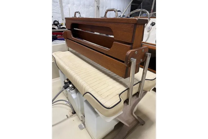 Slide: The Image of 1982 Boston Whaler 17 Montauk boat seat with wooden backrest and storage. - 10