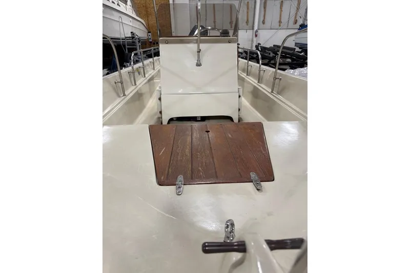 Slide: The Image of 1982 Boston Whaler 17 Montauk interior with wooden hatch and steering console. - 12