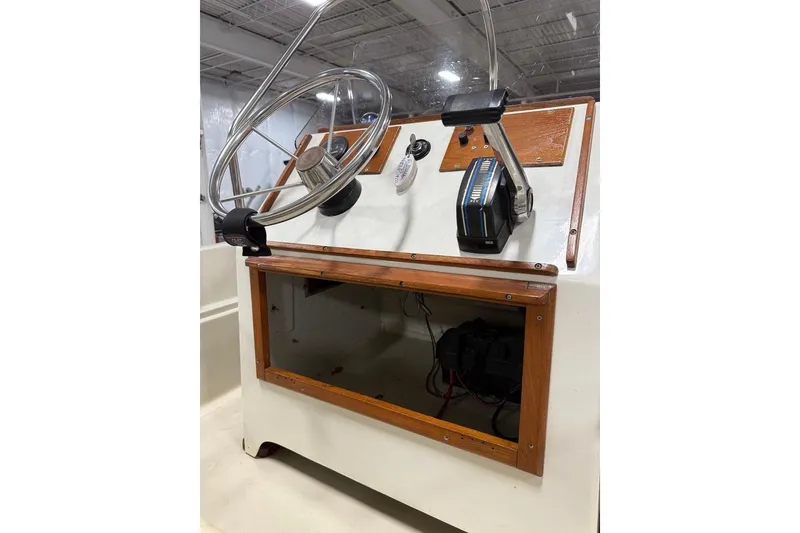 Slide: The Image of 1982 Boston Whaler 17 Montauk boat console with steering wheel and controls. - 13