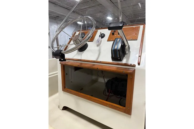 Slide: The Image of 1982 Boston Whaler 17 Montauk boat console with steering wheel and controls. - 14