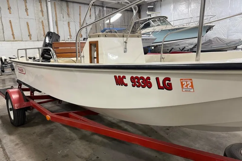 Slide: The Image of 1982 Boston Whaler 17 Montauk boat on red trailer in indoor storage. - 3