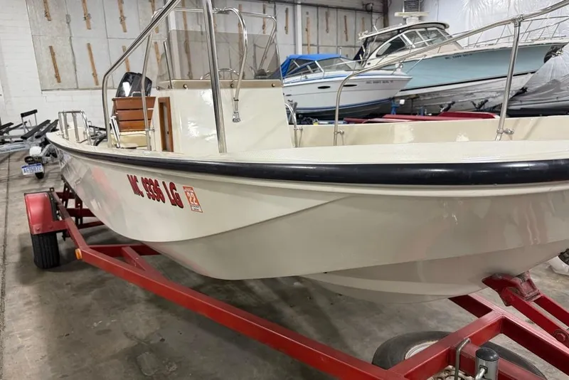 Slide: The Image of 1982 Boston Whaler 17 Montauk boat on red trailer in indoor storage. - 4