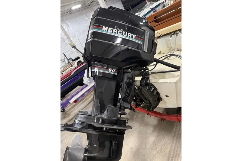 Slide: The Image of 1982 Boston Whaler 17 Montauk with Mercury 90 outboard motor in a garage setting. - 5