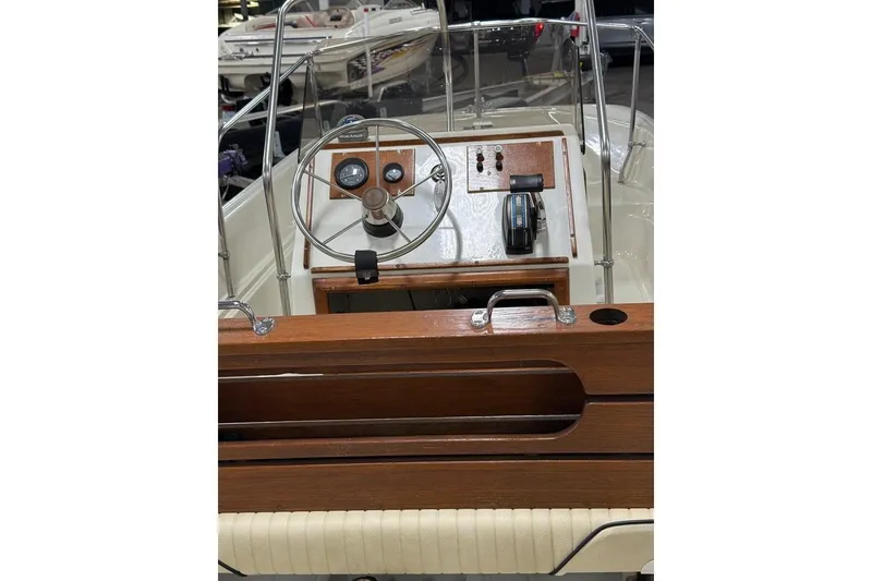 Slide: The Image of 1982 Boston Whaler 17 Montauk boat dashboard with steering wheel and controls. - 6