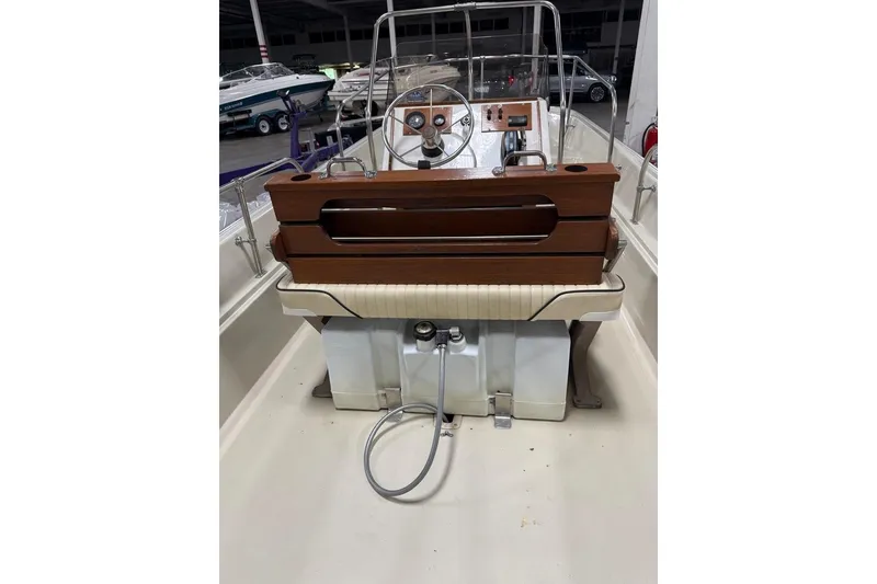 Slide: The Image of 1982 Boston Whaler 17 Montauk boat interior with wooden console and steering wheel. - 7