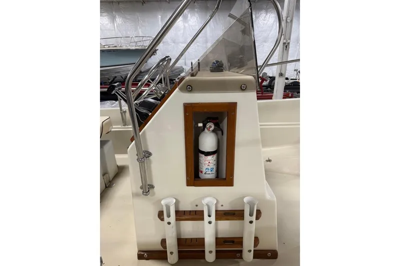 Slide: The Image of 1982 Boston Whaler 17 Montauk console with fire extinguisher and rod holders. - 8