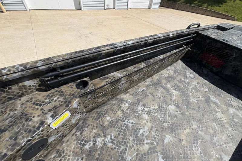 Slide: The Image of 2026 Excel Eclipse boat interior with camouflage pattern and rod holders. - 12