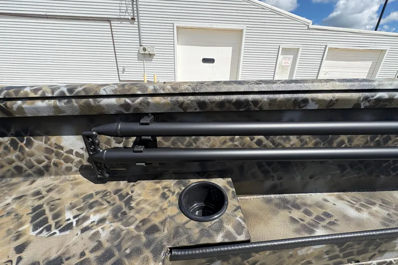 Slide: The Image of 2026 Excel Eclipse boat interior with camouflage design and rod holders. - 13