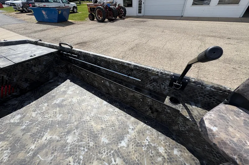 Slide: The Image of Interior of 2026 Excel Eclipse boat with camouflage design and steering handle. - 14