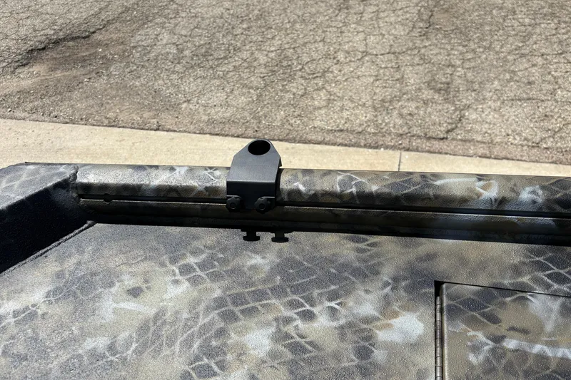 Slide: The Image of Camouflage-patterned Excel Eclipse 2026 boat detail with mounting bracket on textured surface. - 19