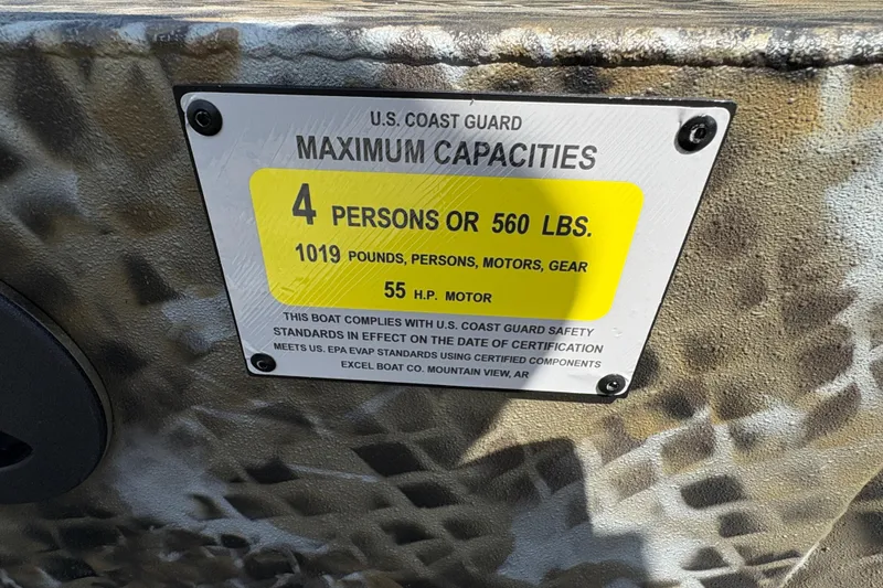 Slide: The Image of U.S. Coast Guard capacity label on 2026 Excel Eclipse boat, 4 persons or 560 lbs limit. - 24