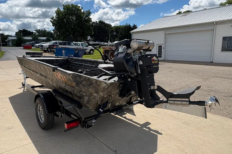 Slide: The Image of 2026 Excel Eclipse boat with motor on trailer, parked outdoors under cloudy sky. - 3