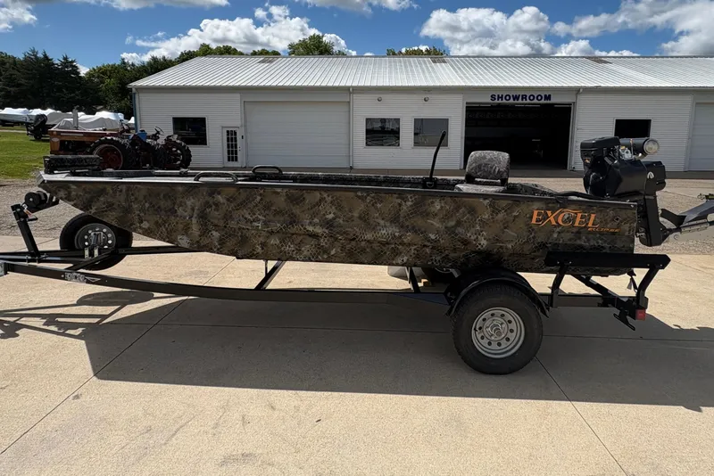 Slide: The Image of 2026 Excel Eclipse boat on trailer outside showroom, featuring camouflage design. - 4