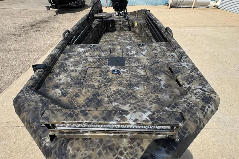 Slide: The Image of 2026 Excel Eclipse boat with camouflage design, parked on concrete surface. - 7