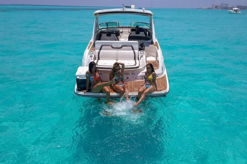 Slide: The Image of 2017 Sea Ray SLX 350 with three people enjoying the turquoise ocean waters. - 10