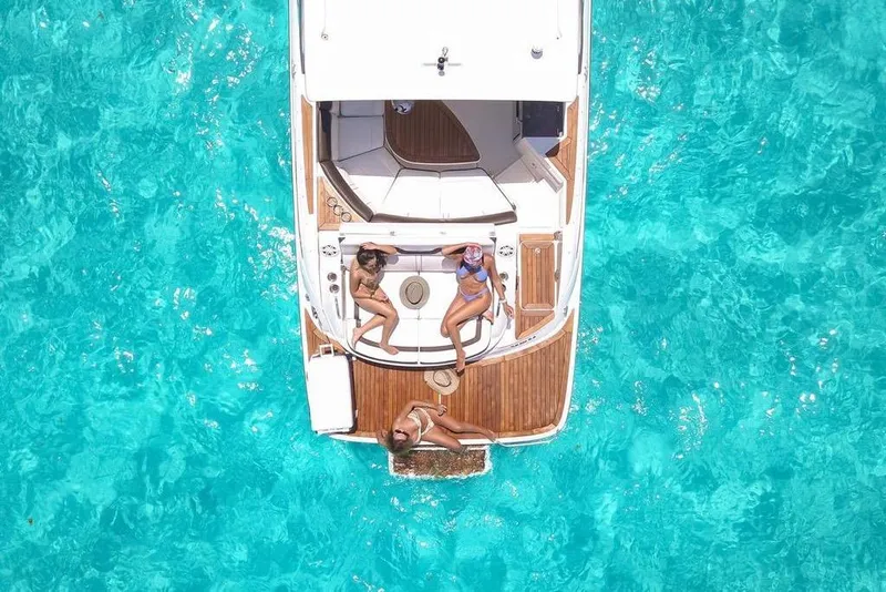 Slide: The Image of Aerial view of 2017 Sea Ray SLX 350 yacht with people relaxing on deck in turquoise water. - 12
