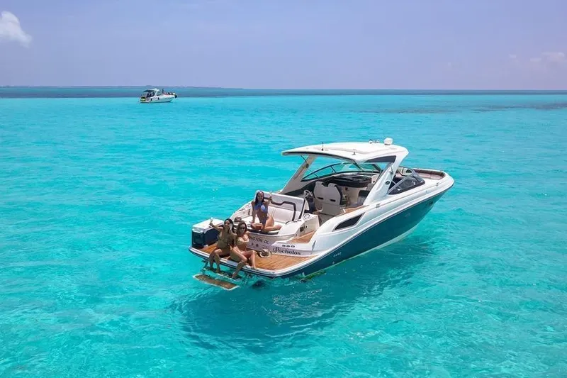 Slide: The Image of 2017 Sea Ray SLX 350 boat on clear turquoise water with people relaxing onboard. - 13