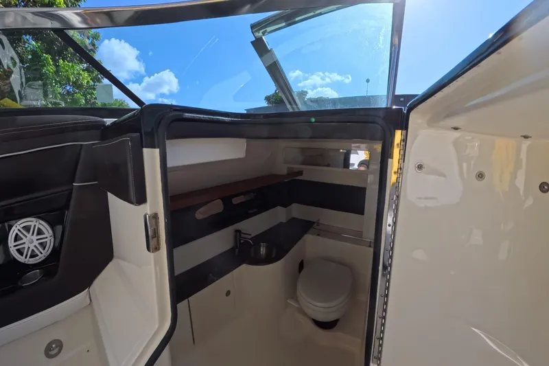 Slide: The Image of Interior view of 2017 Sea Ray SLX 350 boat bathroom with toilet and sink. - 16