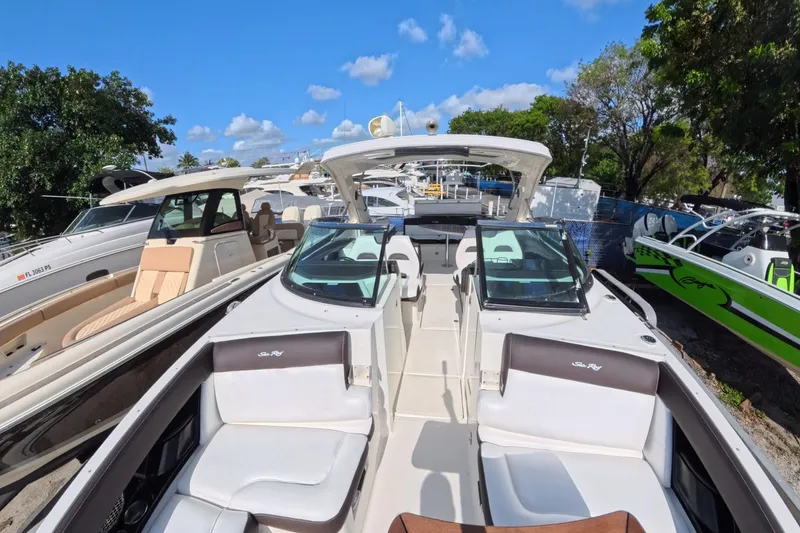 Slide: The Image of 2017 Sea Ray SLX 350 boat with spacious seating, docked under a clear blue sky. - 18