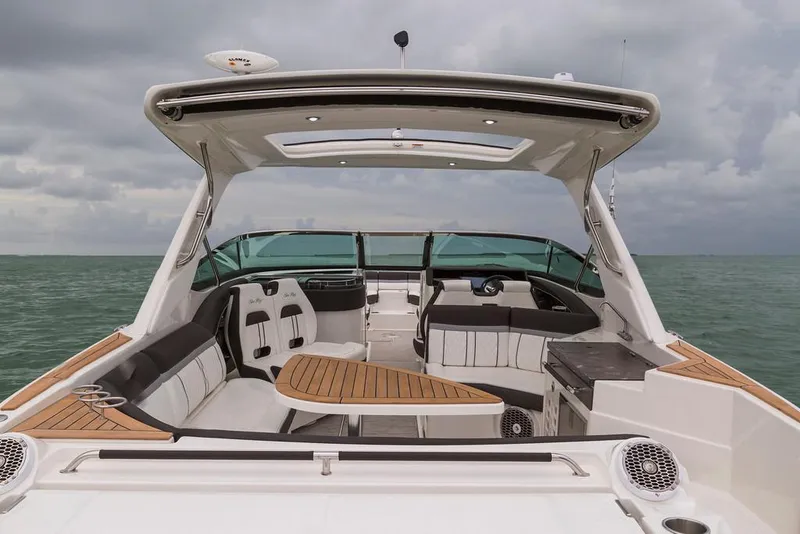 Slide: The Image of Manufacturer Provided Image: 2017 Sea Ray SLX 350 boat interior with seating and table on open water. - 4